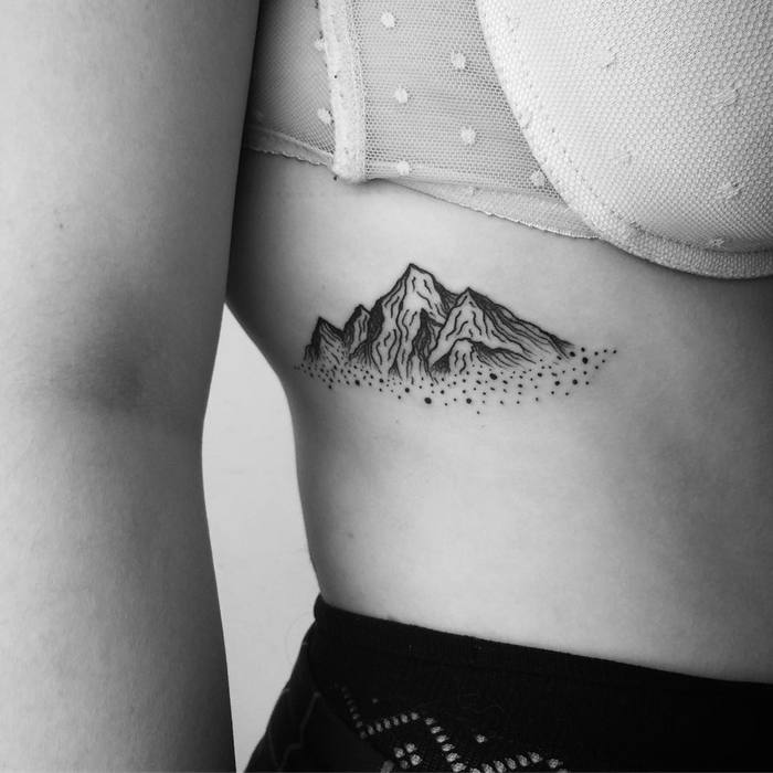 mountain tattoo on rib