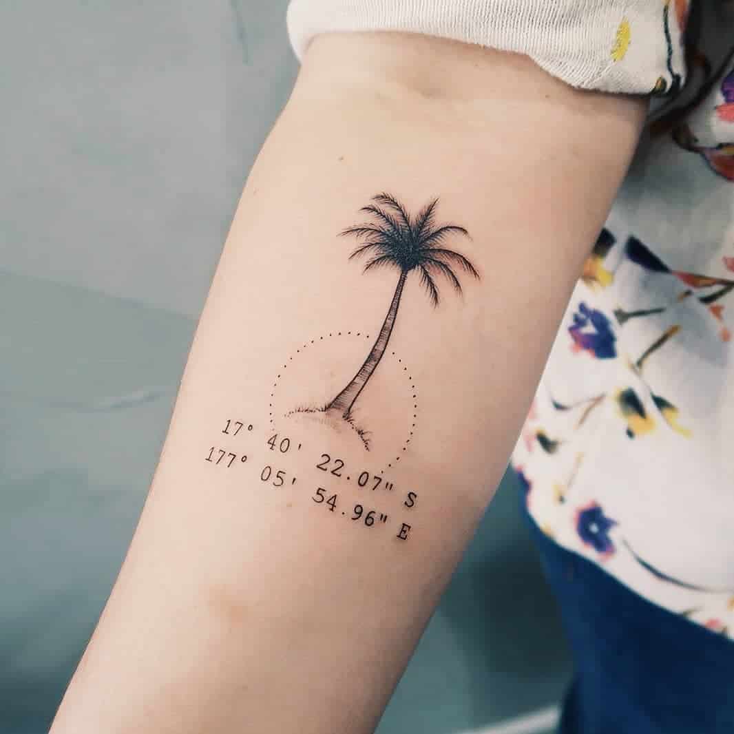 palm tree and coordinates wrist tattoo