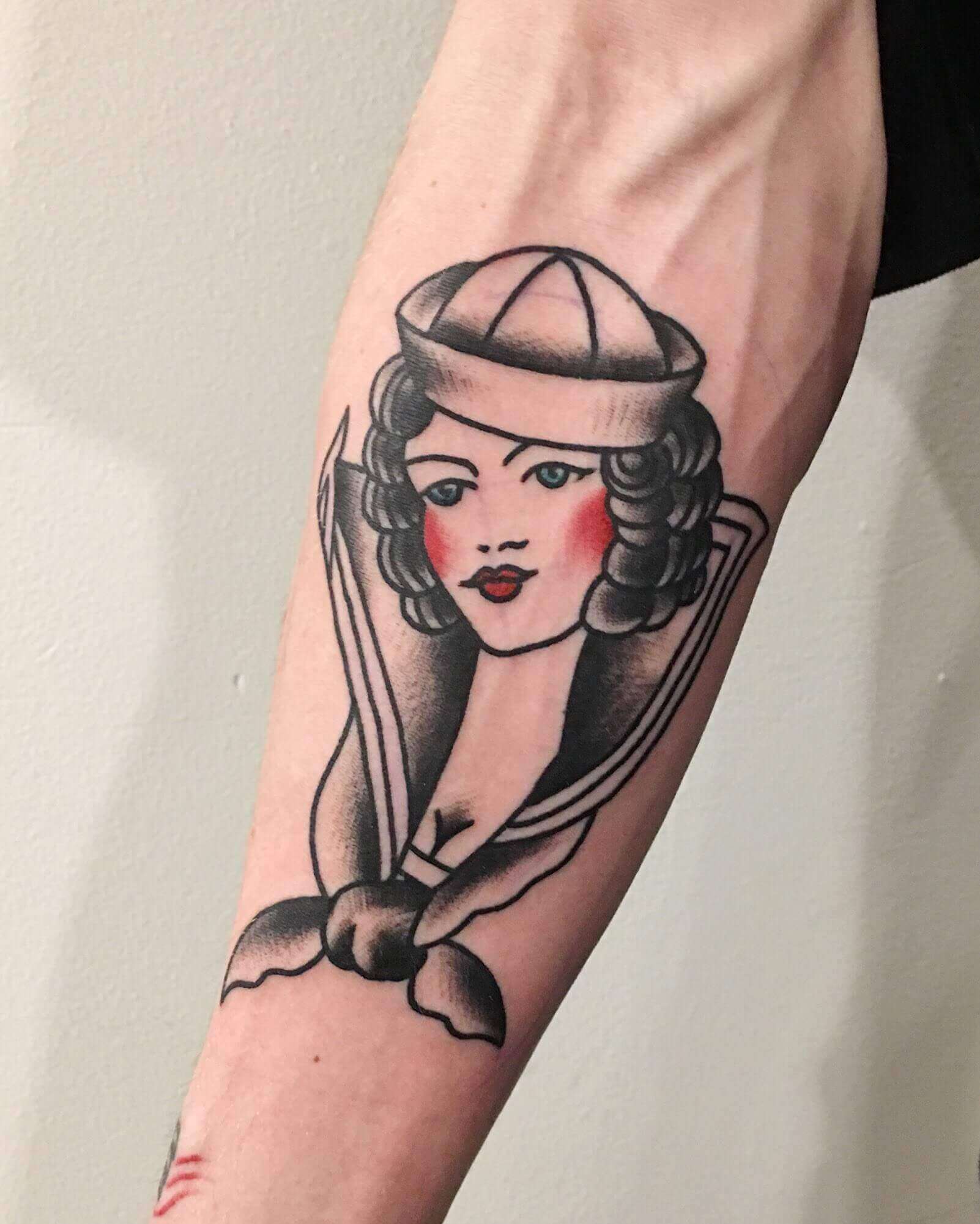 sailor jerry pinup tattoo on arm