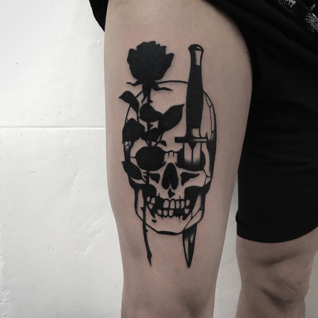 skull and dagger tattoo on thigh
