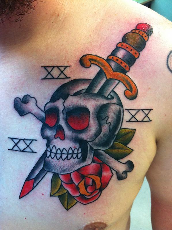 skull and dagger tattoo on chest