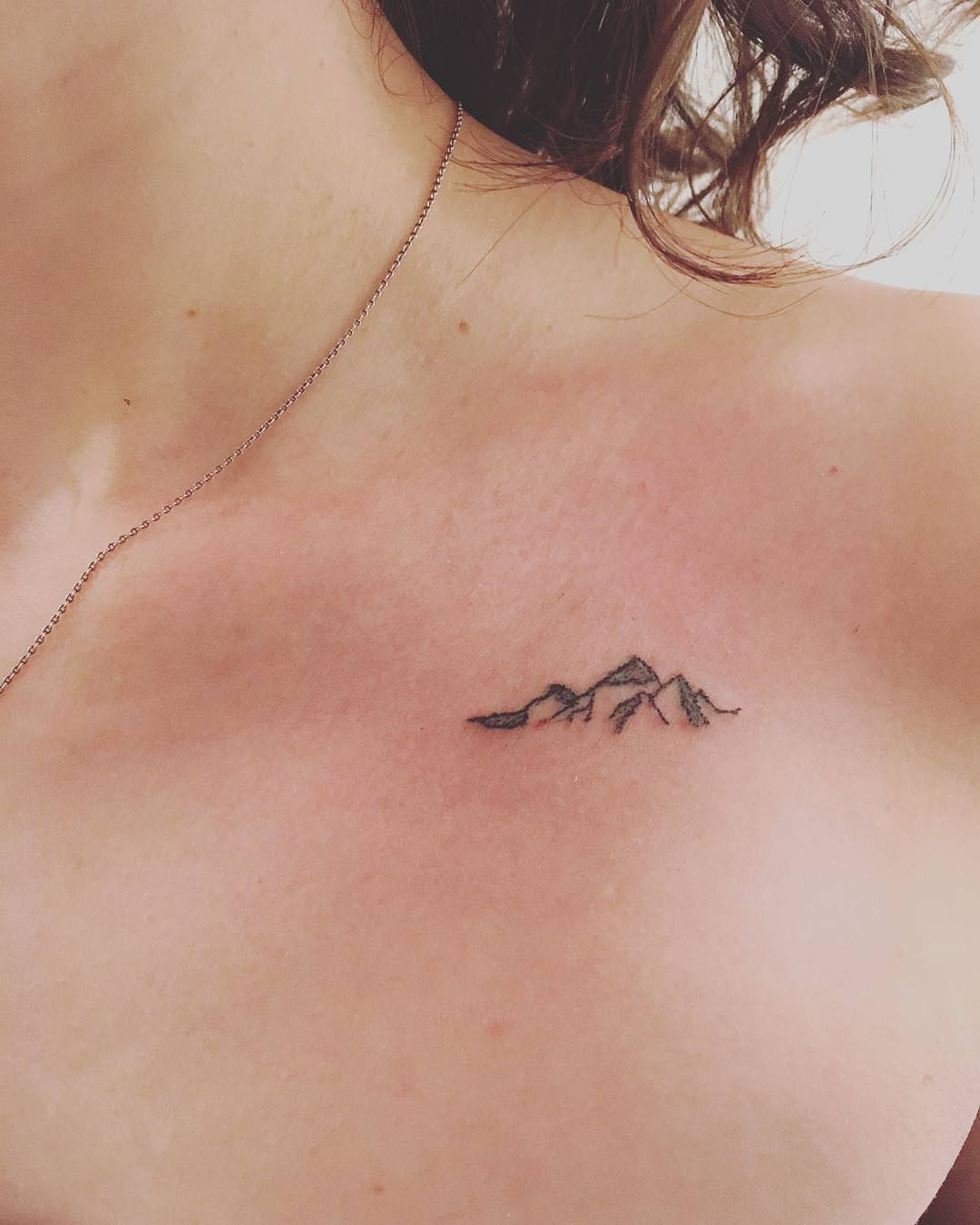 small mountain tattoo on chest