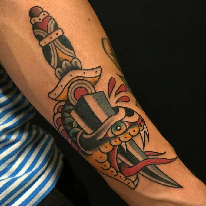 snake and dagger tattoo on arm