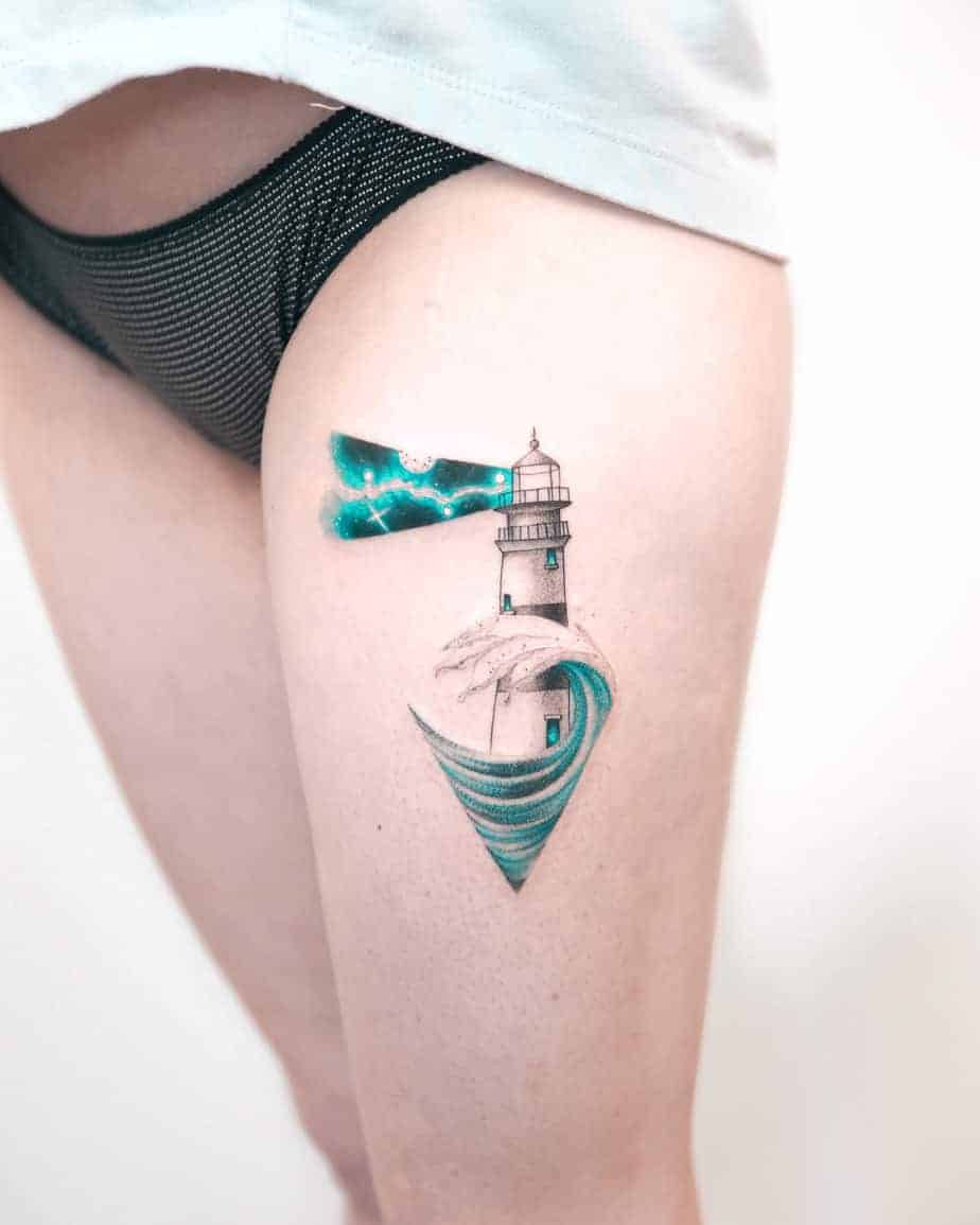 tatouage de phare aquarelle sur la cuisse