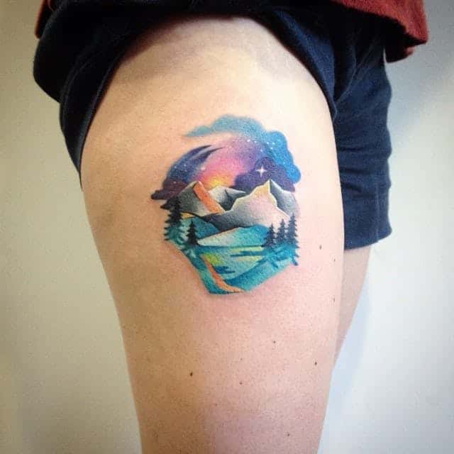 watercolor mountain tattoo on thigh