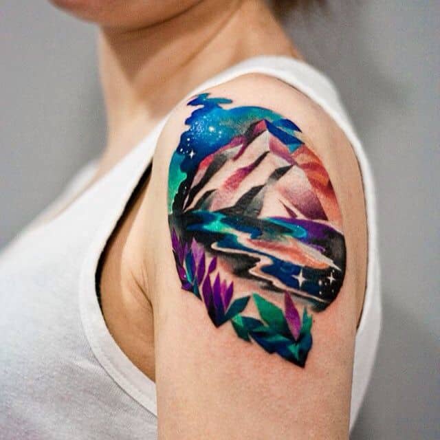 watercolor mountain tattoo on arm