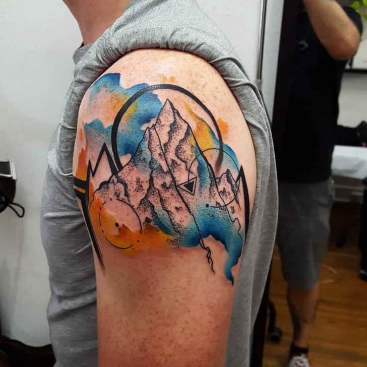 watercolor mountain tattoo on arm