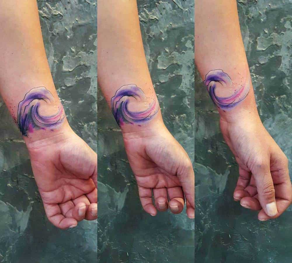 watercolor ocean tattoo on wrist