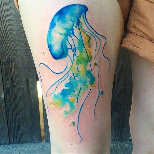 watercolor sea creature tattoo on thigh