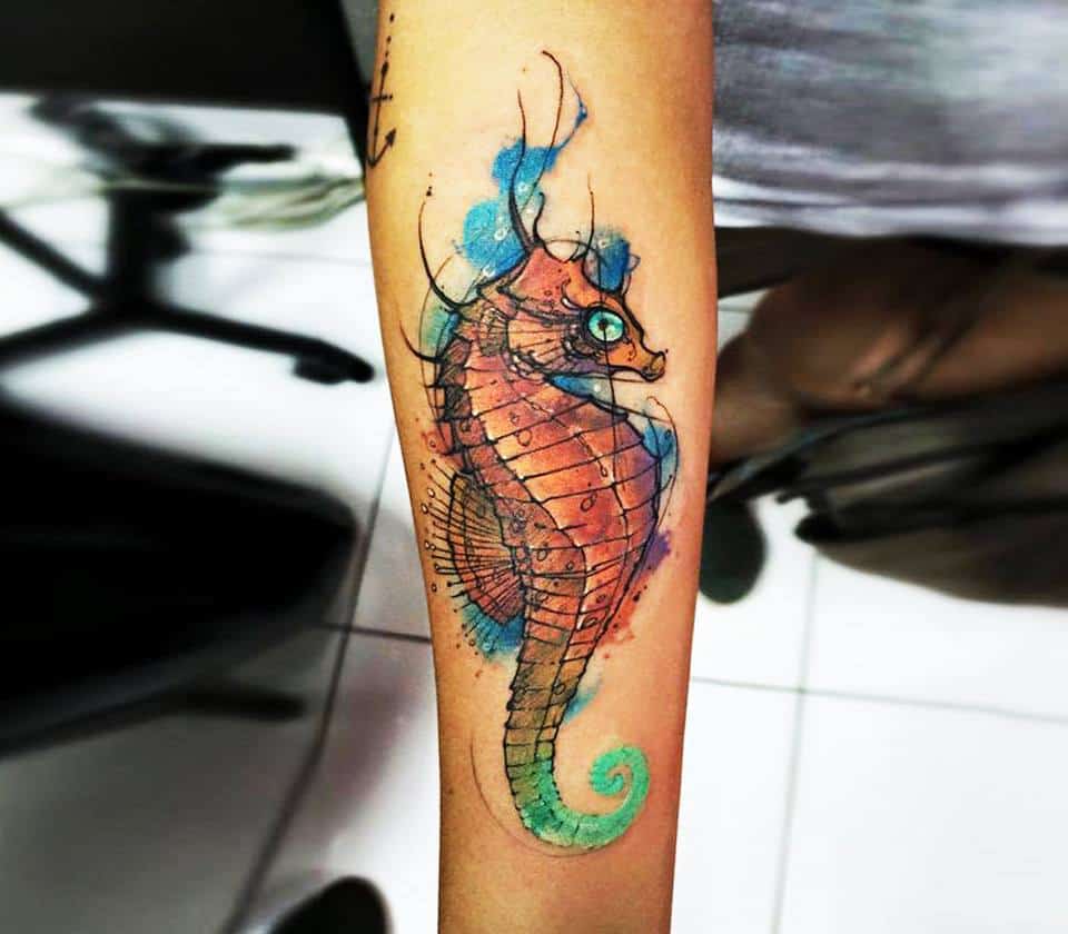 watercolor seahorse tattoo on arm