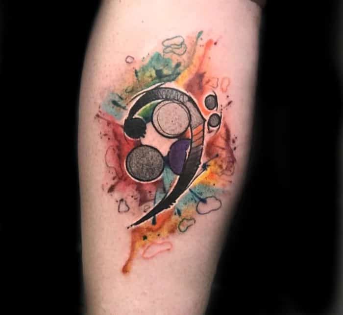 watercolor semicolon tattoo on arm