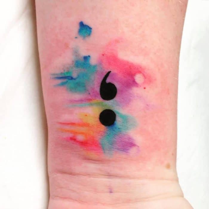 watercolor semicolon tattoo on wrist