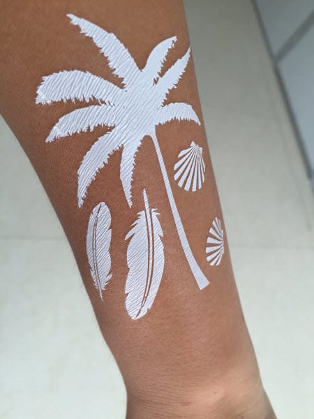 white ink palm tree on arm