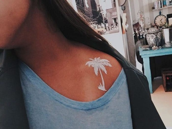 white ink palm tree on shoulder