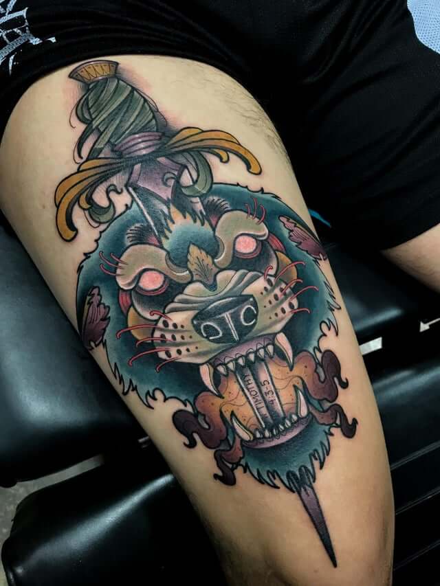 wolf and dagger tattoo on thigh