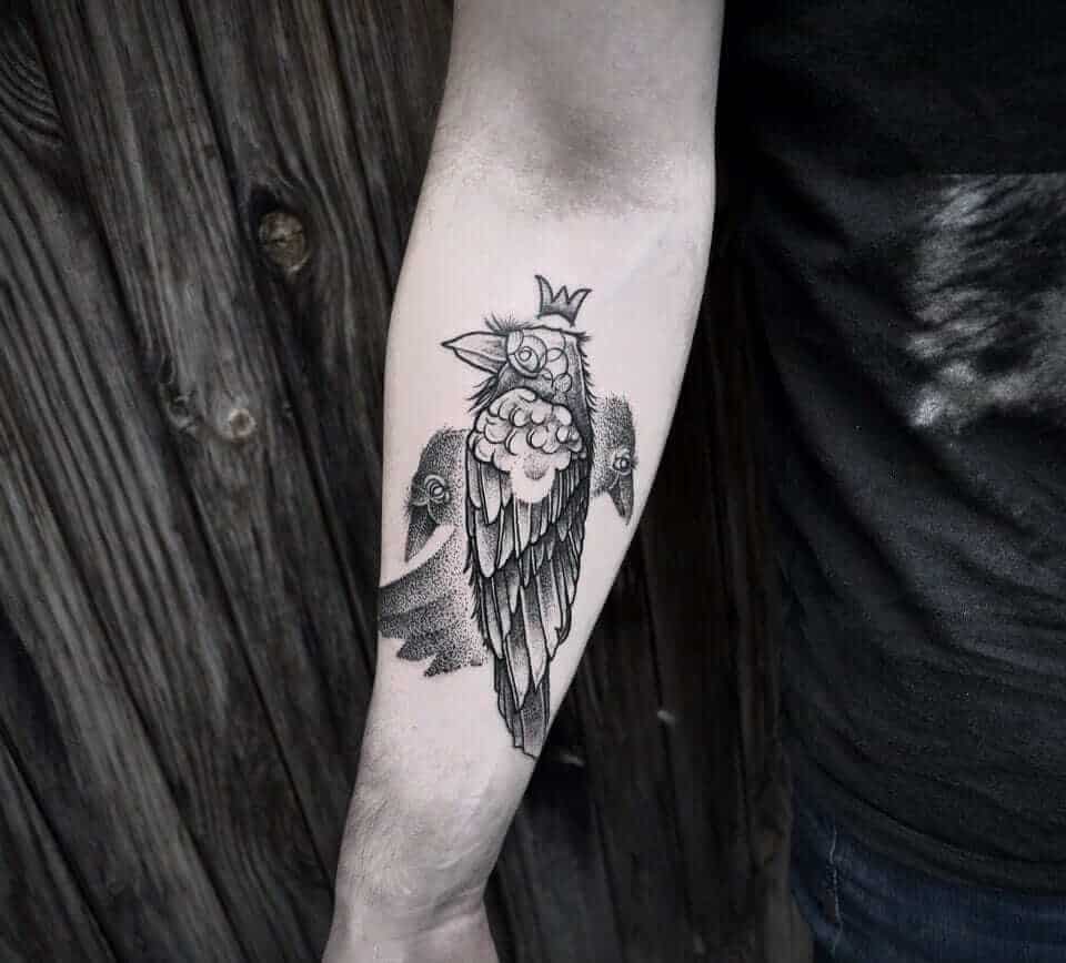 abstract crow raven tattoo on arm