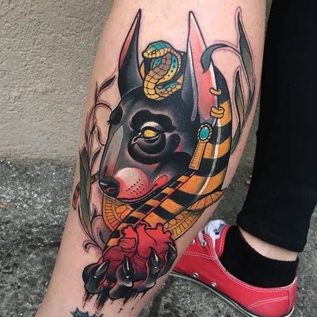 colored anubis tattoo on leg