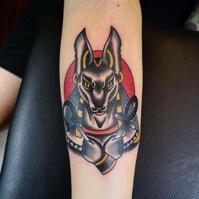 colored anubis tattoo on arm