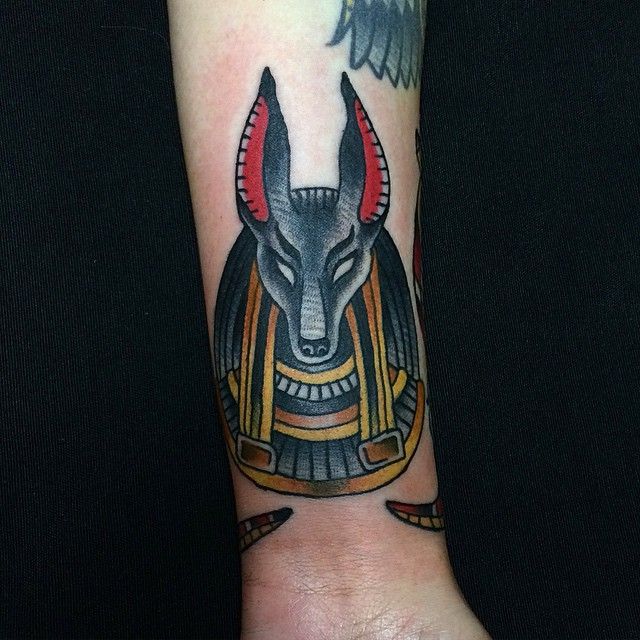 colored anubis tattoo on arm