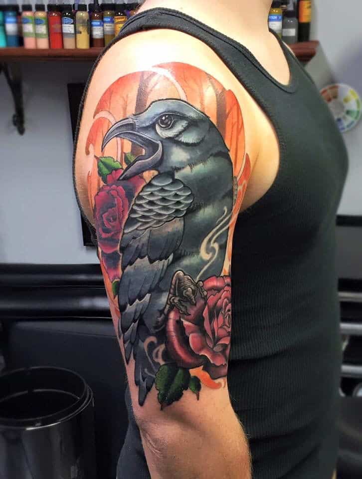 colored crow raven tattoo on arm