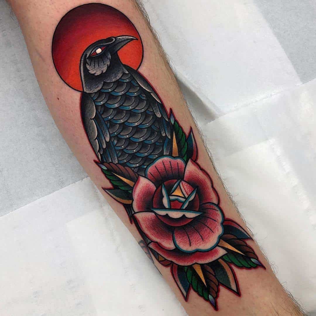 colored crow raven tattoo on arm