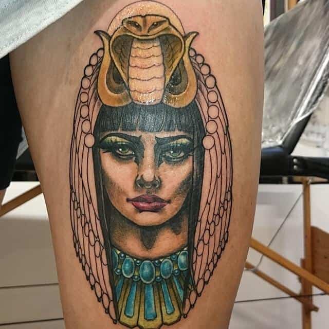 colored egyptian tattoo on thigh