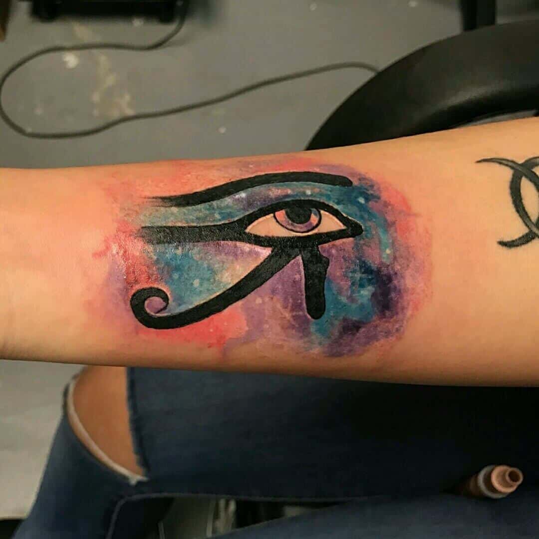 colored eye of horus tattoo on arm