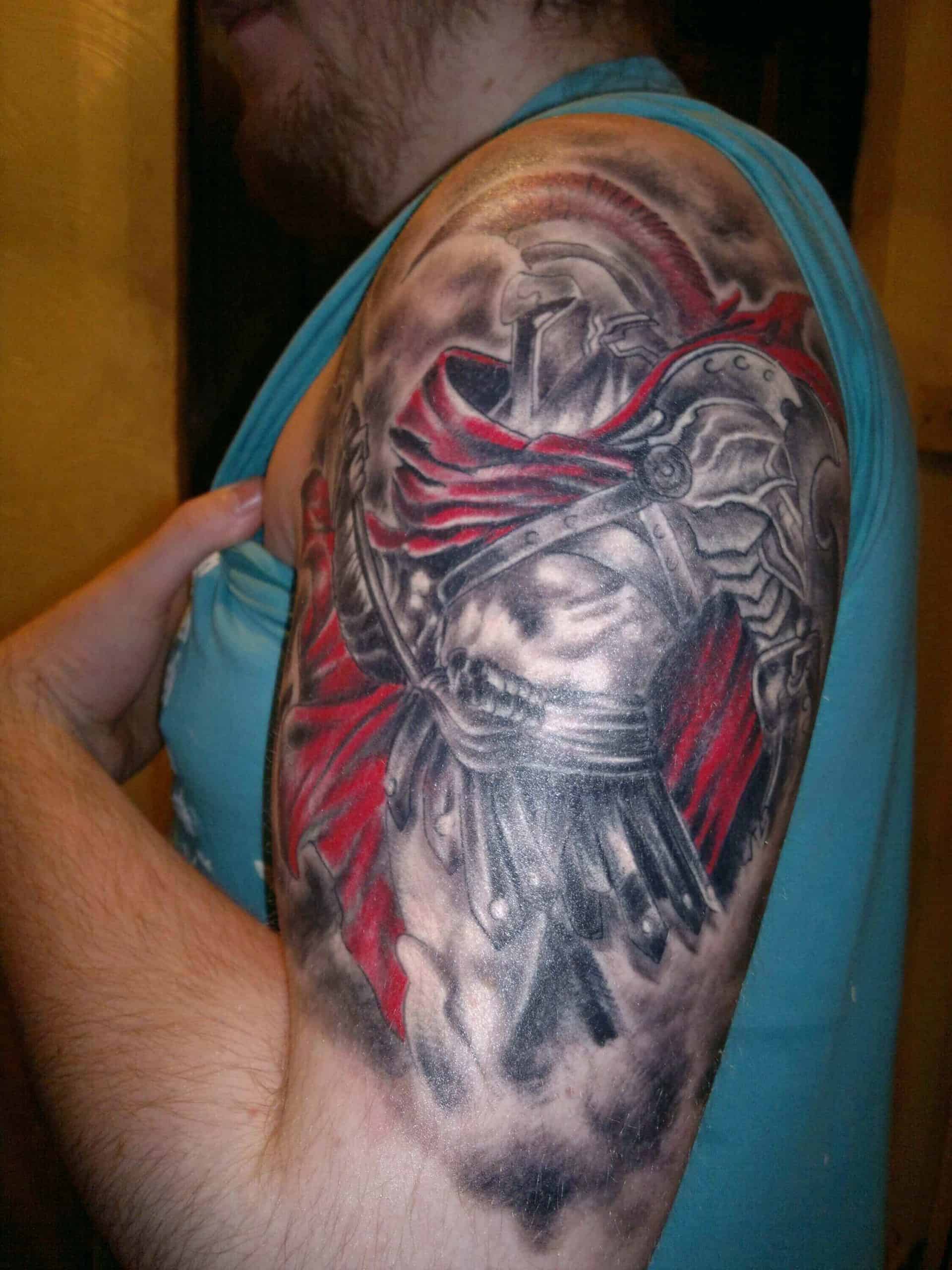 colored god of war tattoo on arm