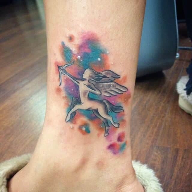 colored sagittarius tattoo on leg