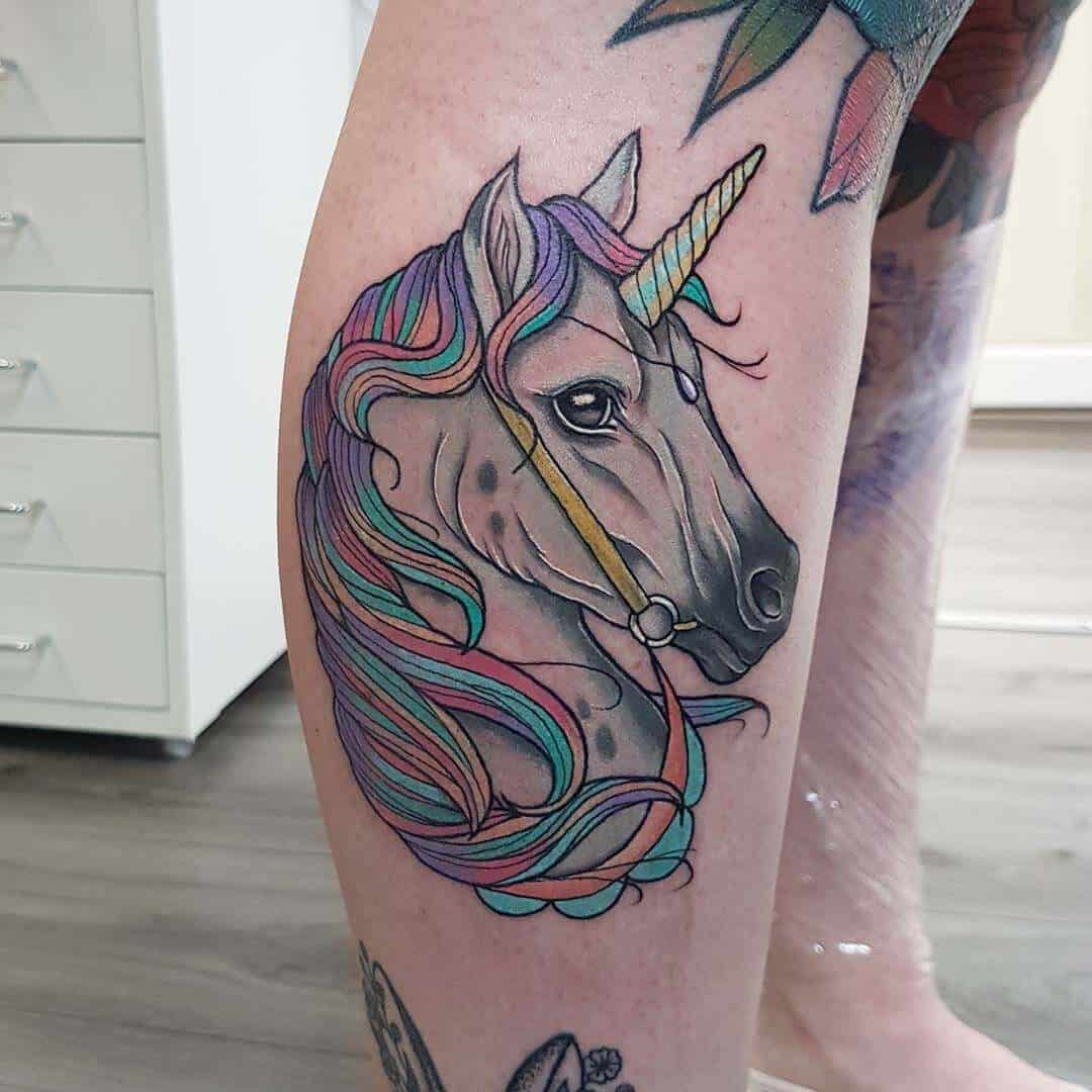 colorful unicorn tattoo on leg