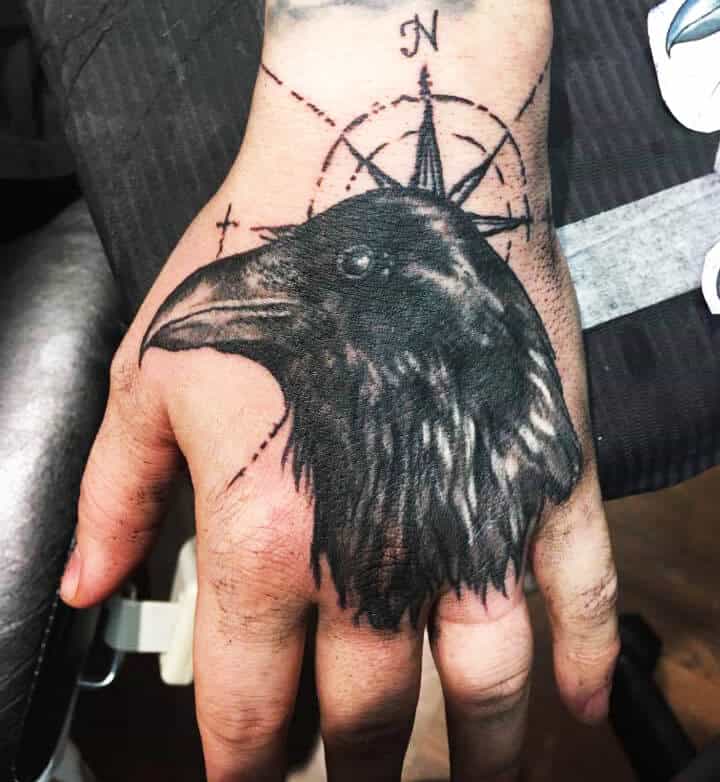 crow raven hand tattoo