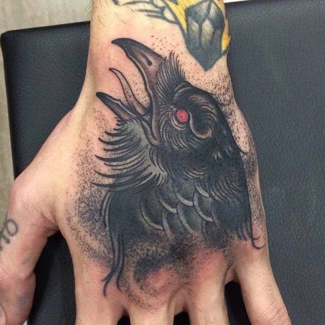 crow raven hand tattoo