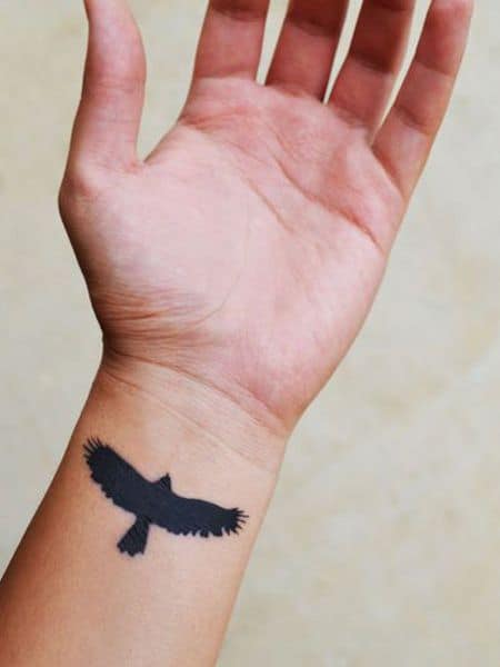 crow raven wrist tattoo