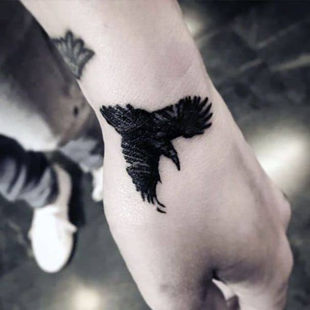 crow raven wrist tattoo
