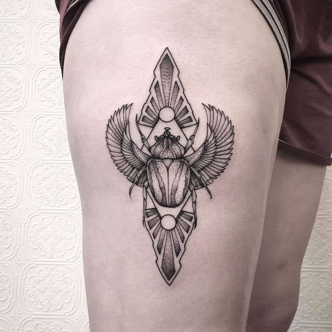 geometric egyptian tattoo on thigh