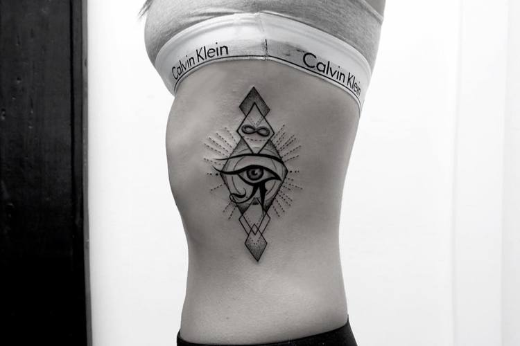 geometric eye of horus tattoo on rib