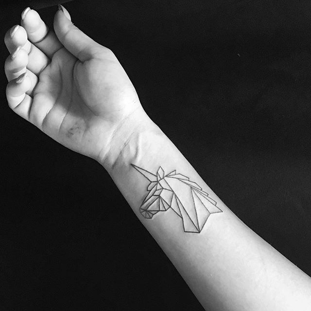 geometric unicorn tattoo on wrist
