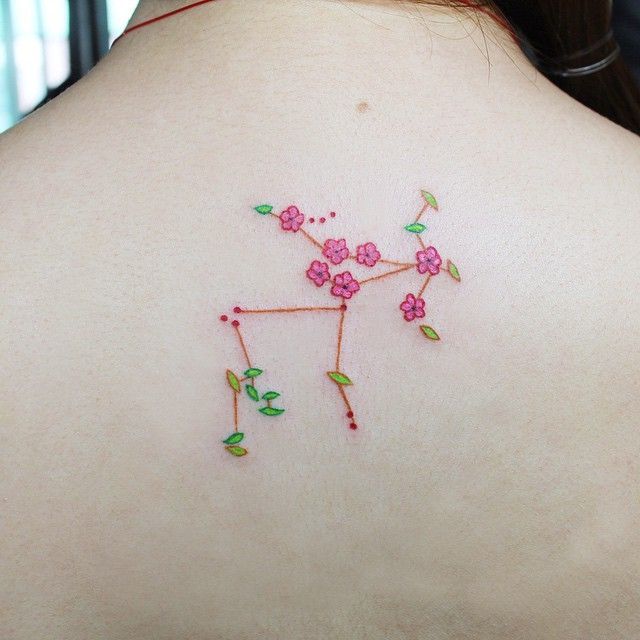 girly sagittarius tattoo on back