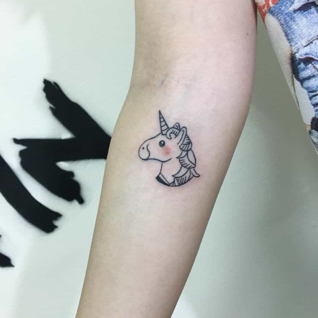 small unicorn tattoo on arm.