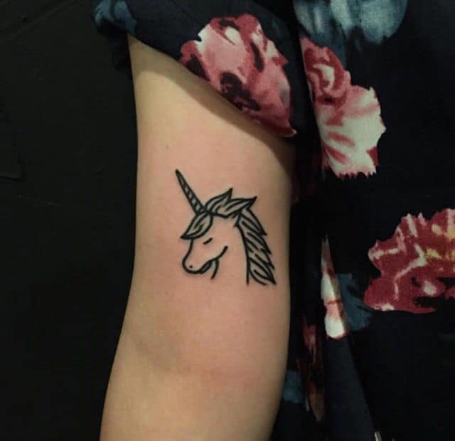small unicorn tattoo on arm
