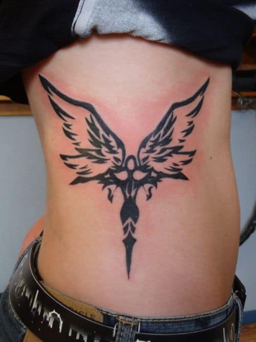 tribal saint michael tattoo on rib