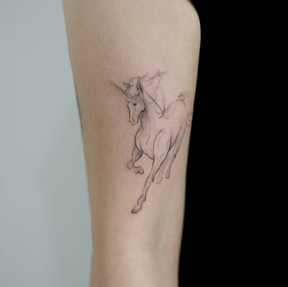 unicorn tattoo on arm