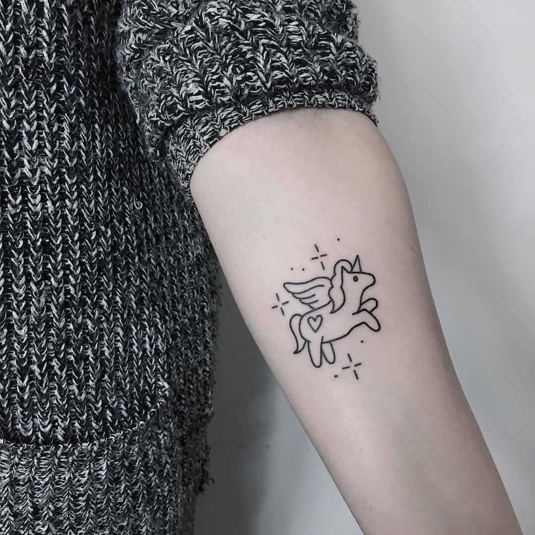 Fine line unicorn tattoo on the inner arm.