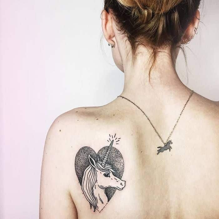 Minimalistic style unicorn tattoo located on the upper