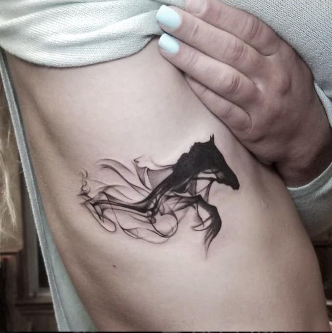 unicorn rib tattoo