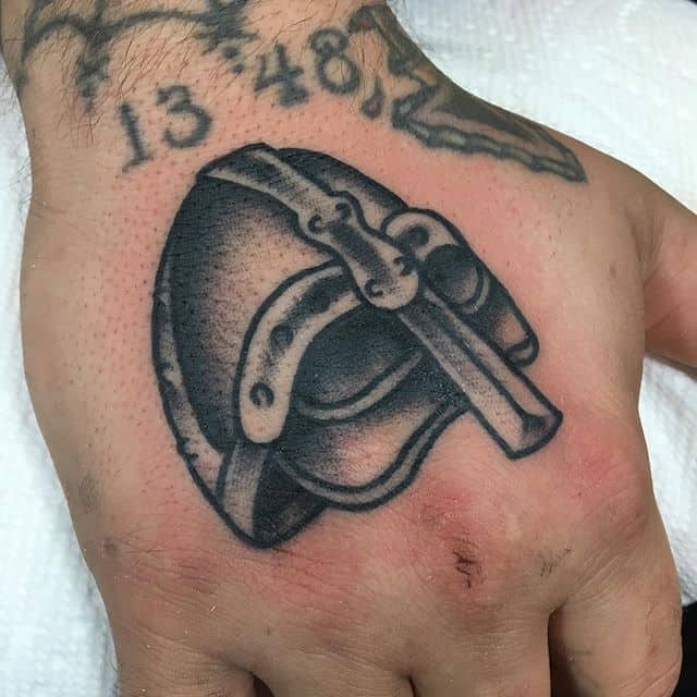 viking helmet tattoo on hand