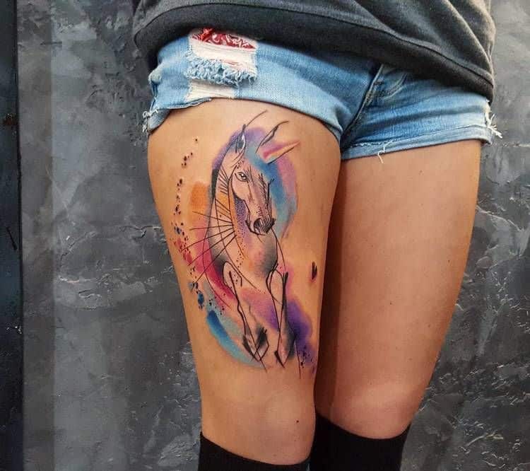 watercolor unicorn tattoo on thigh
