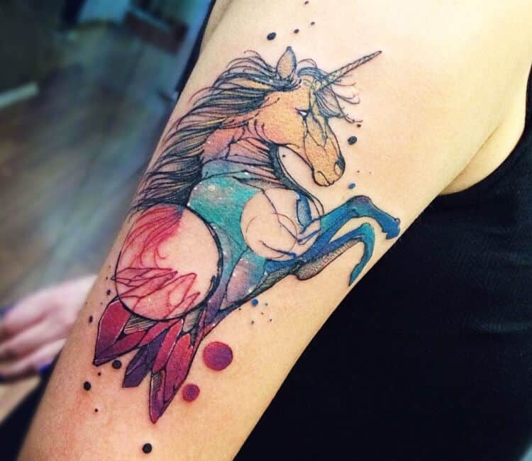 watercolor unicorn tattoo on arm