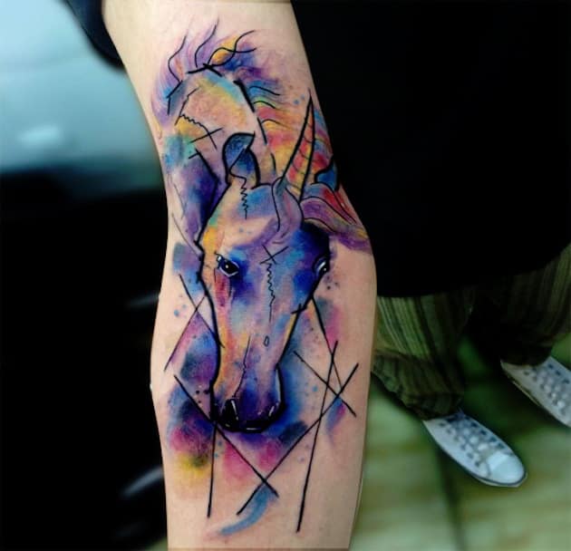watercolor unicorn tattoo on arm