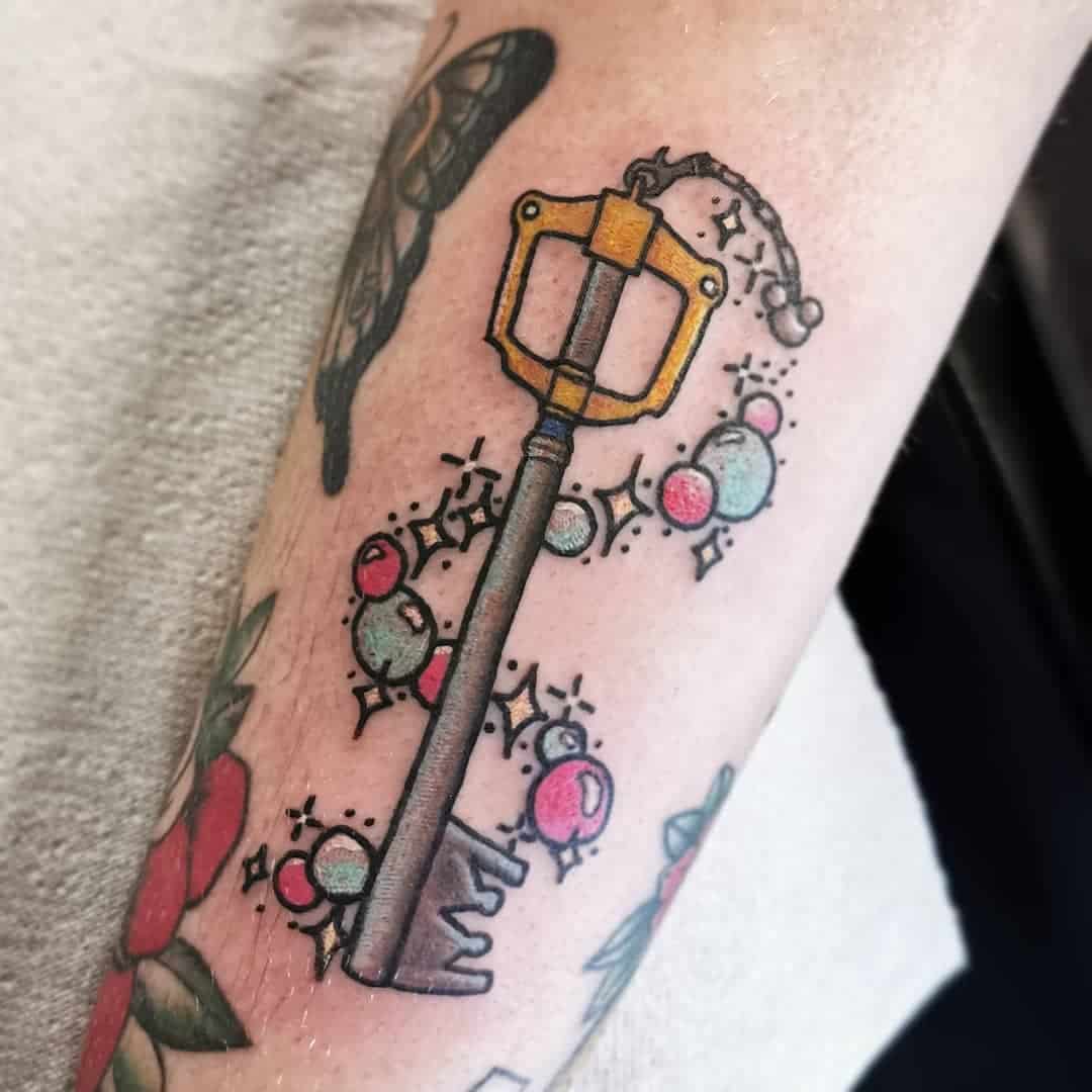 colored keyblade tattoo on arm